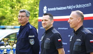 Trzech mundurowych stoją w rzędzie.