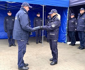 Zdjęcie przedstawia przekazywanie klucz przez policjantów.